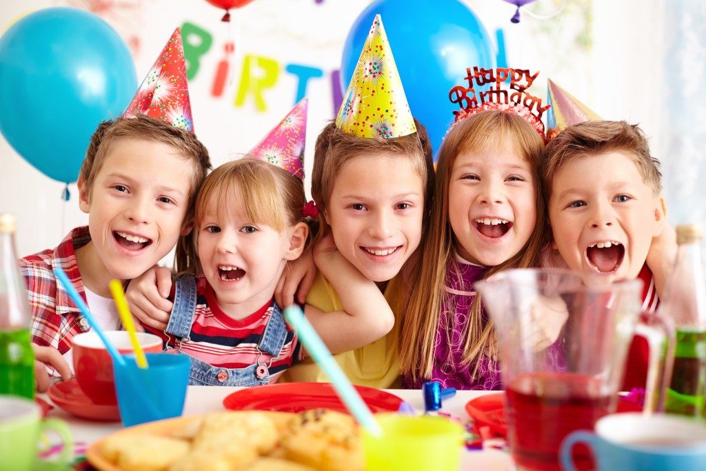 Kids waring party hats at a birthday celebration