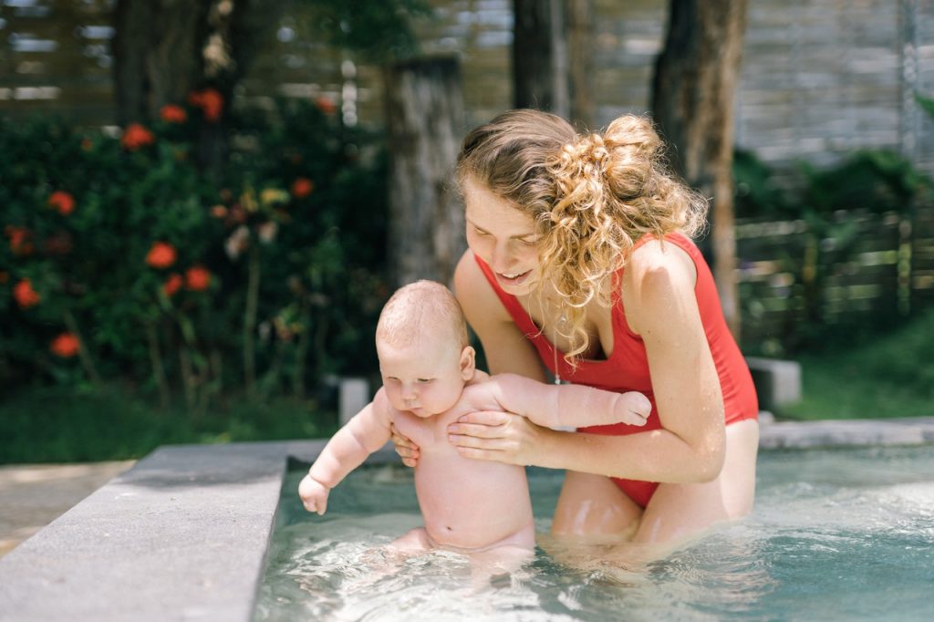 mother and her baby in a pool