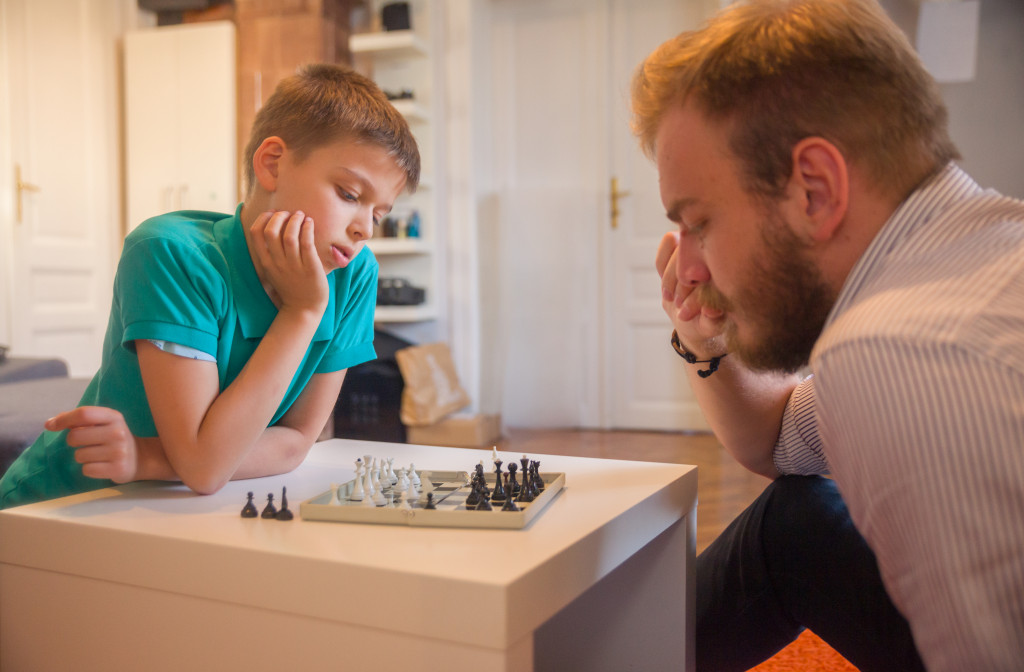 father and son playing chess