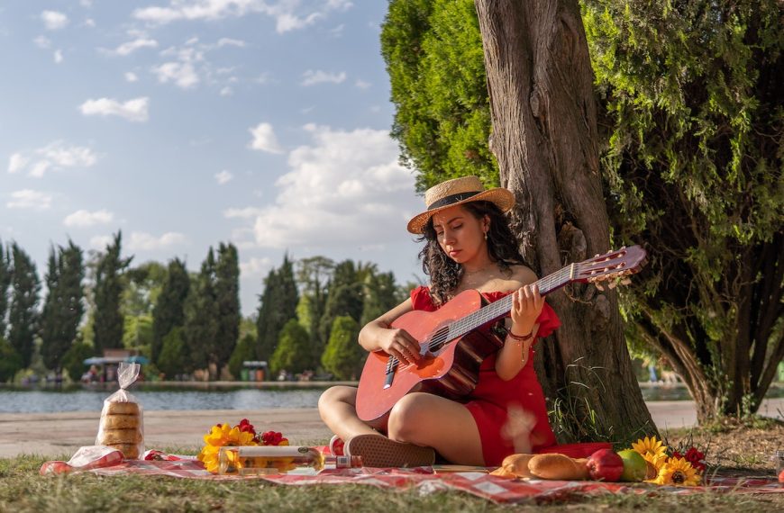 boho fashionista enjoying her peace while playing guitar