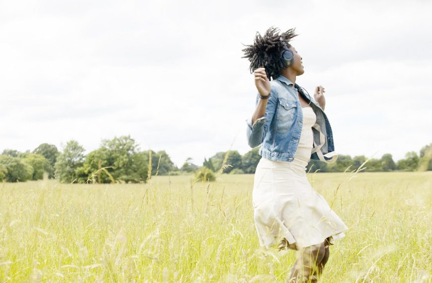 woman listening to music around nature